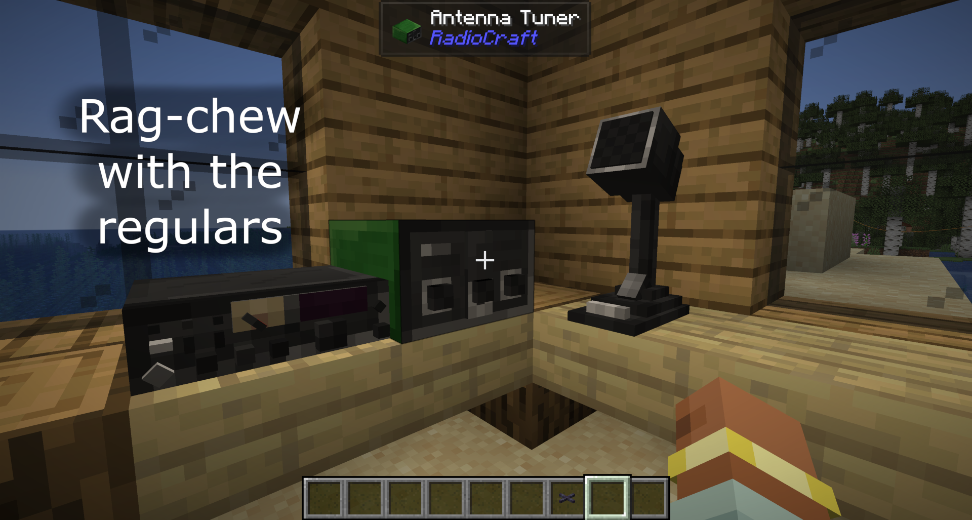 Inside a Minecraft shack showing an HF transceiver, green Antenna Tuner block, and desk microphone