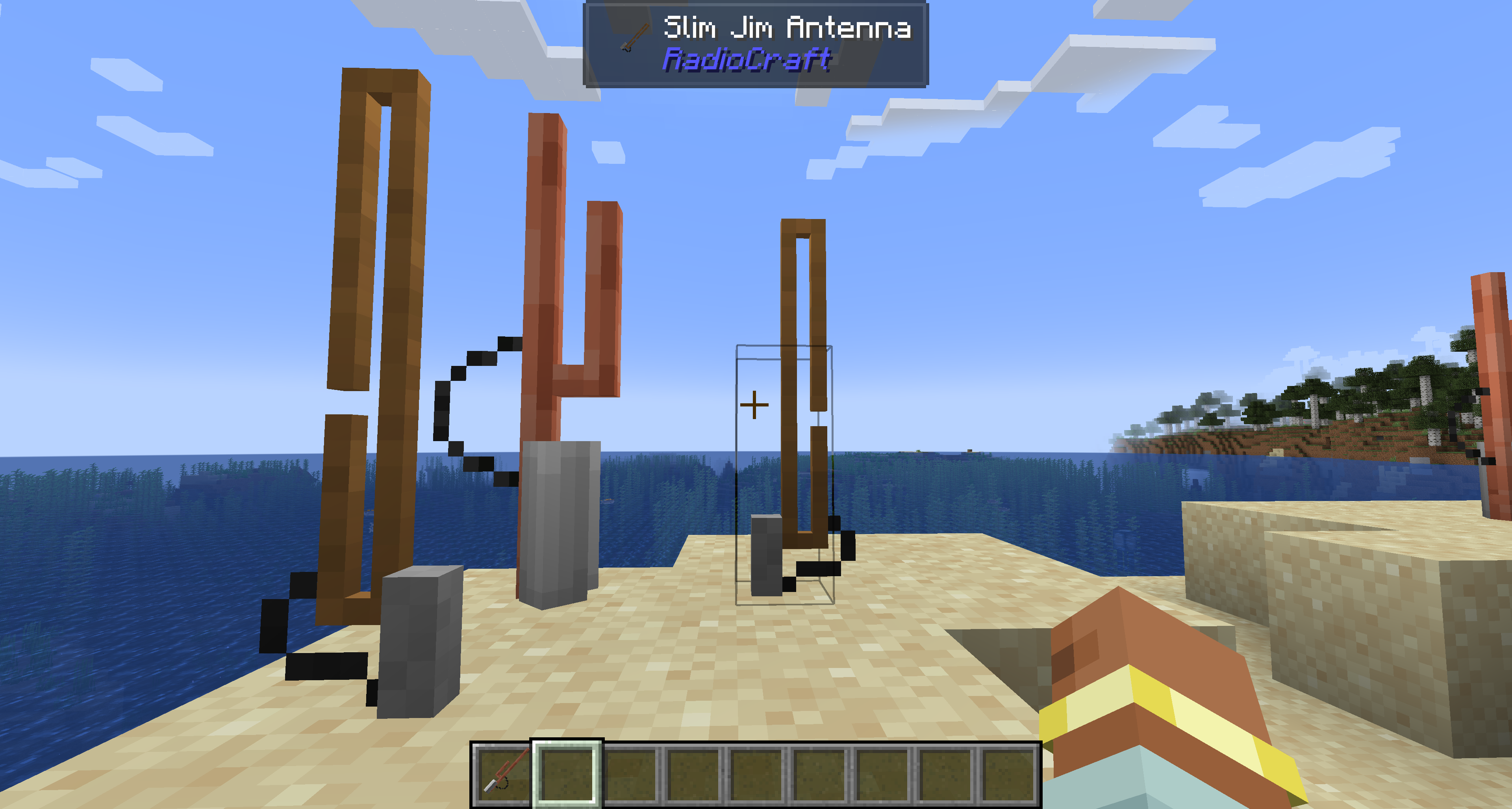 Copper Slim Jim and J-Pole antennas mounted on a beach in Minecraft